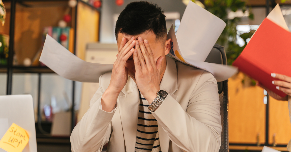 A stressed man in an office settting.